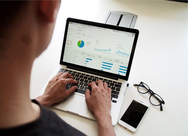 bar and line graph data is displayed on a laptop screen. 