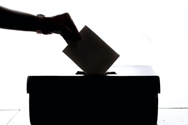 a black and white image of a ballot being posted. Midterm Election