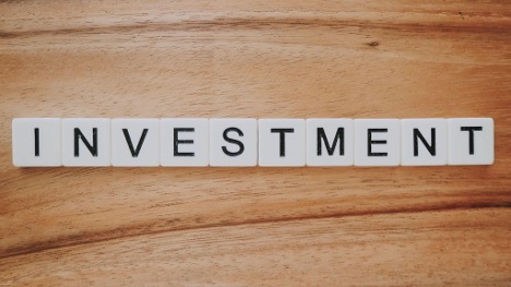 Investment spelled out with scrabble tiles