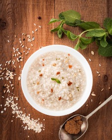 A bowl of porridge on a wooden table Invest