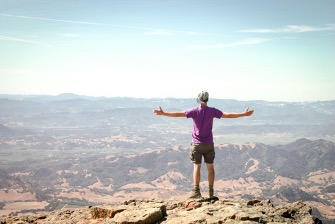 man standing on edge of cliff