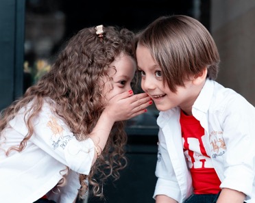 two kids whispering to each other Power of Merchant Cash Advances