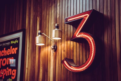 Large number three illuminated wall sign.