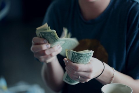 White hands counting dollar bills. Investing