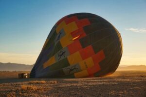 A hot air balloon deflating in a large field Purchasing Power