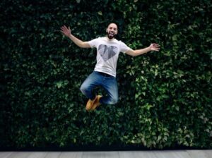 A man jumps in the air with a smile on his face