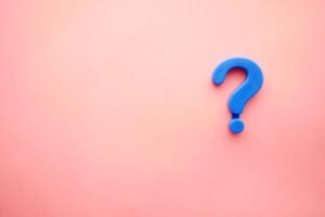 A blue question mark on a pink background Rising Interest Rates