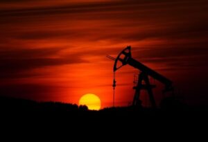 Exterior view of an oil pump silhouetted against the sunset Rates Hikes
