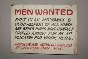A vintage sign showing a notice of jobs available. Misery Index