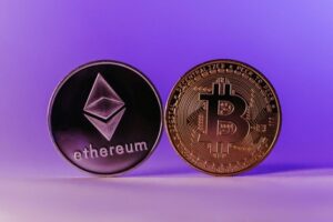 Bitcoin and Ethereum Coins Standing against a Purple Background Cryptocurrencies