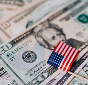 Close-up of US currency and US flag for ‘Bank of America's CEO Predicts Economic Soft Landing: What It Means for You’