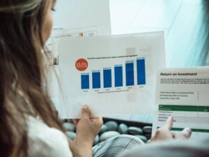 Woman looking at bar graphs for ‘Unlocking Superior Returns with Supervest: A Strategic Guide for Family Offices and RIAs’ RIAs