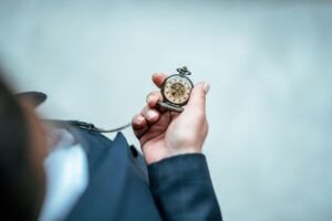 Exterior of a person checking their pocket watch for ‘APY Illusions: How High-Interest Promises Can Mislead Investors’