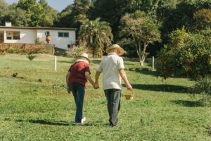 Exterior, a couple walk hand-in-hand across a sumptuous garden, for “How to Leverage Monte Carlo Simulations to Improve Your Investment Strategy”